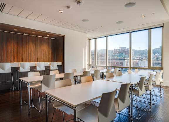 A conference room with a long table and chairs.