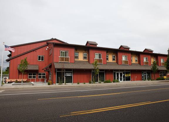 A red building with a flag on the left side.