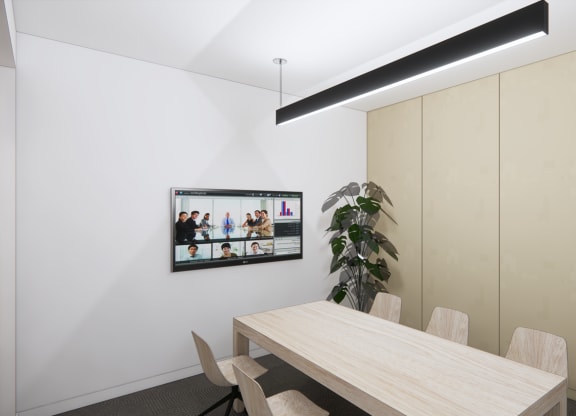 a dining room with a table and a tv on the wall