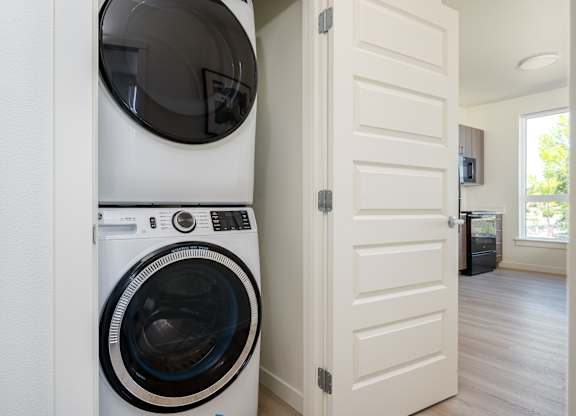 A white washing machine and dryer in a laundry room.