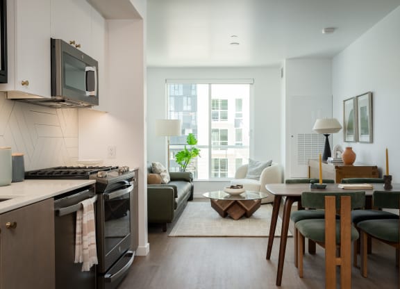 a living room with a kitchen and a dining room at Slabtown Square Apartments, Portland , OR 97209