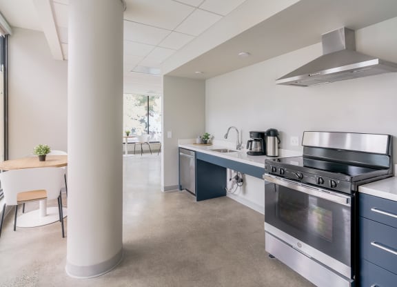 a kitchen with a stove top oven next to a column