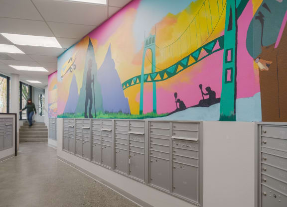 a mural of the brooklyn bridge is painted on the wall of a school hallway
