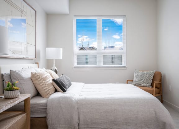 a bedroom with a large bed and a window