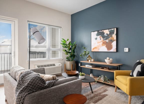 a living room with two couches and a yellow chair