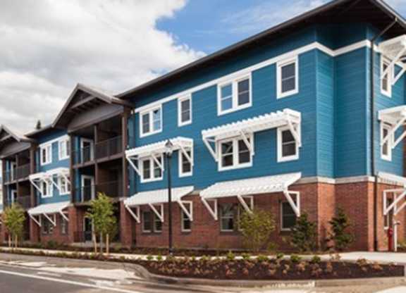 A blue and white building with a red brick base.