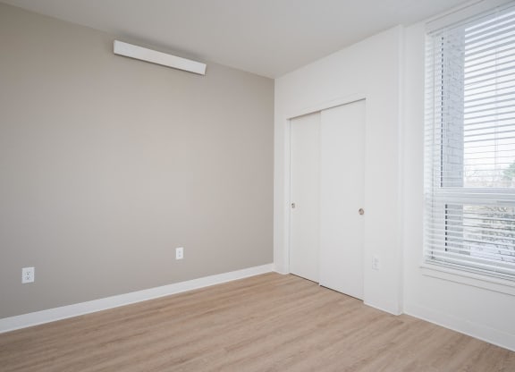 an empty room with a window and a door