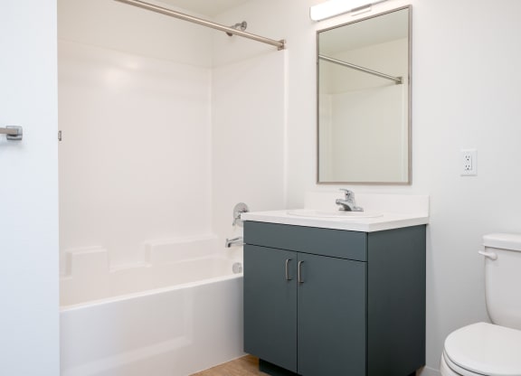 a bathroom with a sink toilet and a mirror