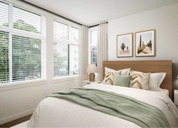 a bedroom with a bed and three windows