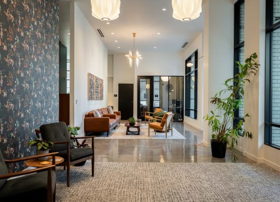 a living room with couches and chairs and a large rug