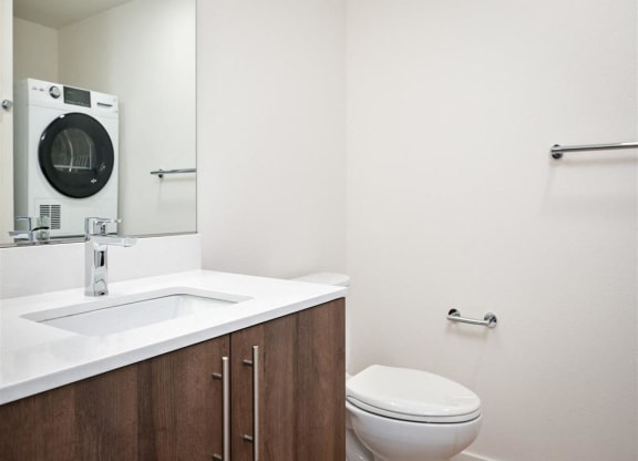 a bathroom with a toilet and a sink and a mirror