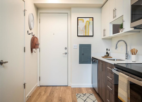 a small kitchen with a sink and a door to the bathroom