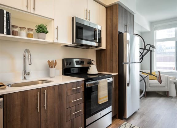 a kitchen with a sink and a refrigerator and a microwave