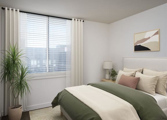 a bedroom with a bed and a window and a plant