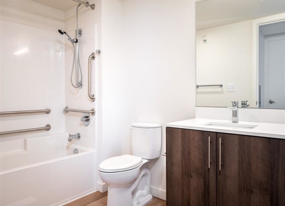 a bathroom with a toilet and a tub and a sink