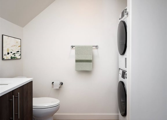 a small bathroom with a toilet and a washing machine