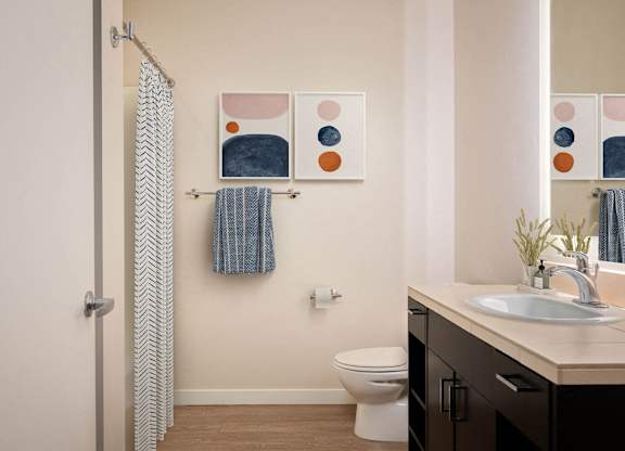 a bathroom with a shower curtain and a sink and a toilet