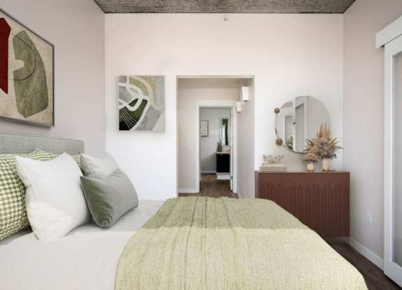 a bedroom with a bed and a dresser and a bathroom