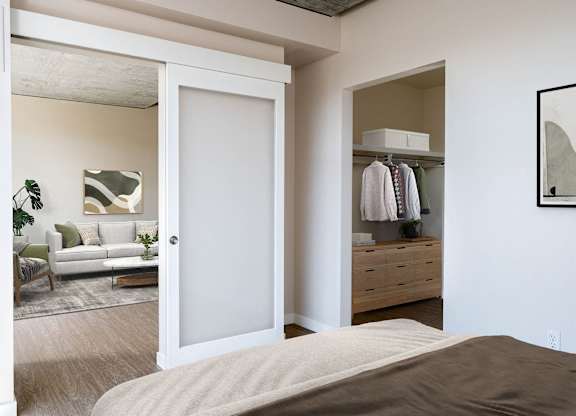 a bedroom with a bed and a closet with a mirror