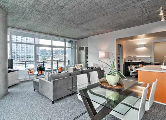 a living room with a glass table and a couch