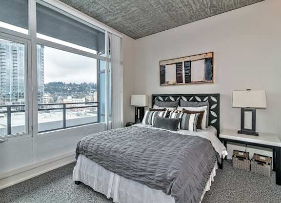 a bedroom with a bed and a large window