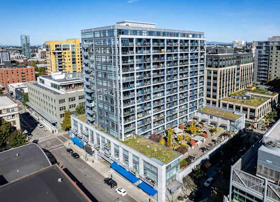 an aerial view of a tall building with a green roof