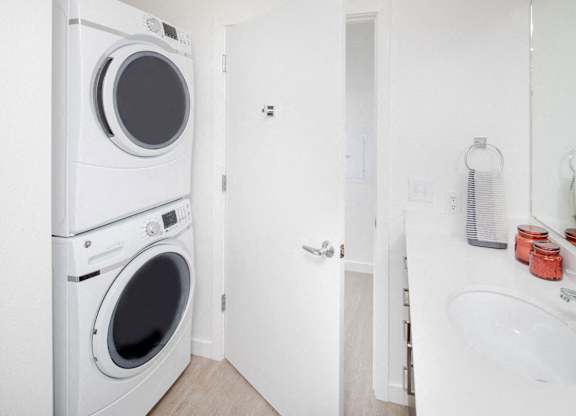 A white washing machine and dryer in a small laundry room.