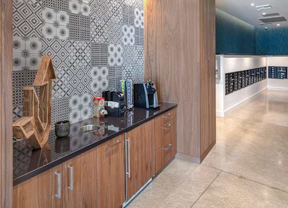 A kitchen with wooden cabinets and a black counter top.