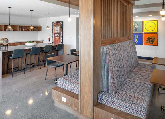 A living room with a striped couch and a dining table.