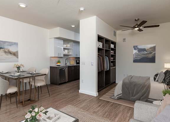 A modern living room with a dining table and chairs.