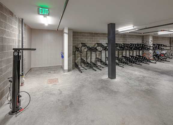 A bike parking area with a green exit sign.
