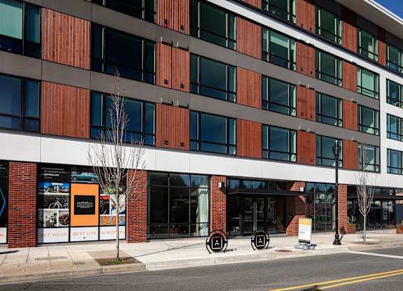 A modern building with a combination of brown and white panels.