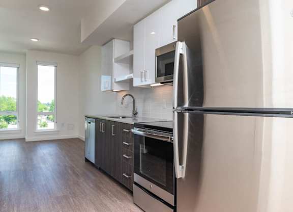 A modern kitchen with a stainless steel refrigerator.