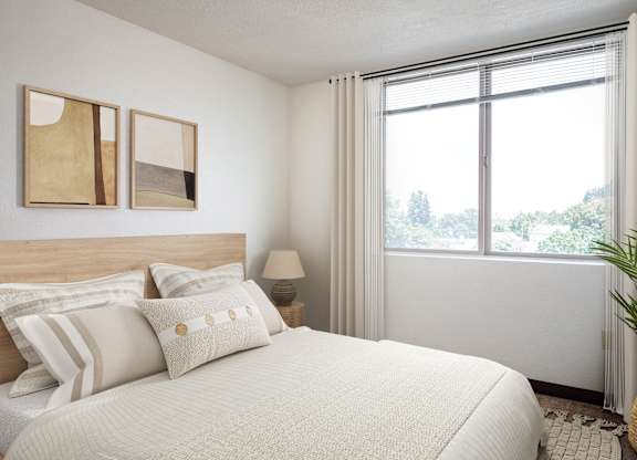 a bedroom with a bed and a large window