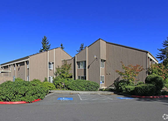 A large building with a parking lot in front of it.
