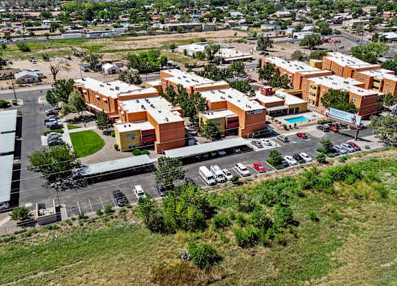 A large building complex with a parking lot in front.