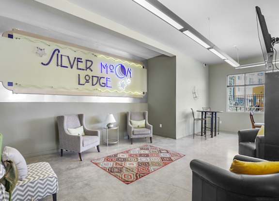A sign that says Silver Moon Lodge hangs above a row of chairs.