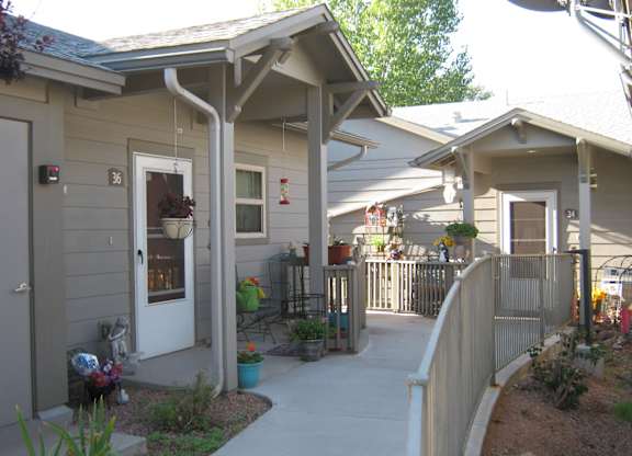 A small building with a white door and a porch.