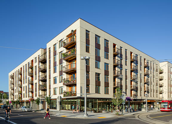 A modern building with balconies on the second floor.