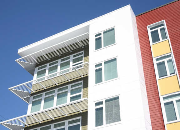 A white building with a red and yellow building next to it.