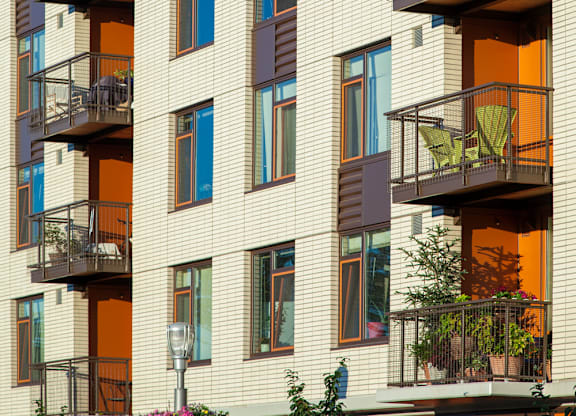 A building with balconies and plants on them.