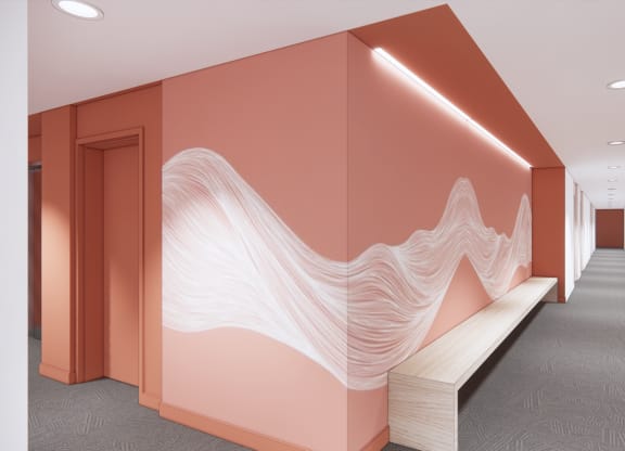 a hallway with a mural on the wall and a bench