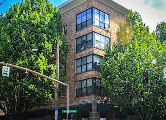 A building with a street sign that says "ONE WAY" is shown.