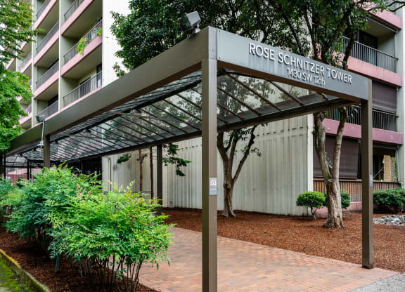 an exterior view of the rosemary tower condominiums in front of a building