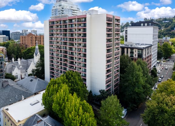 an aerial view of a tall building in a city
