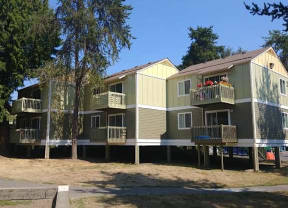 A row of houses with balconies and flower pots.