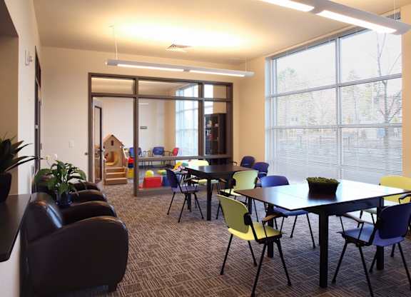 A conference room with a long table and chairs.