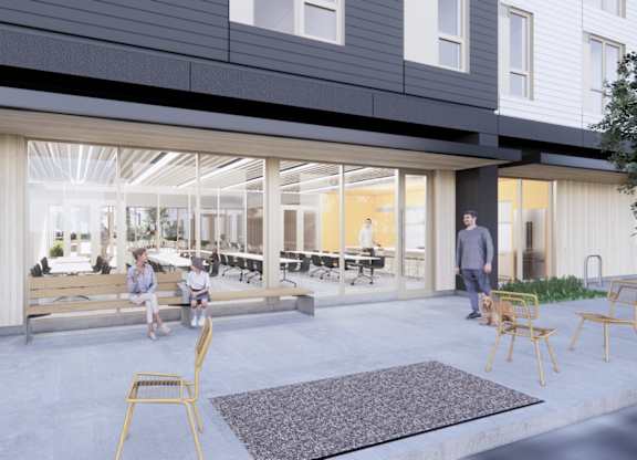 A modern outdoor seating area with people sitting and standing around.