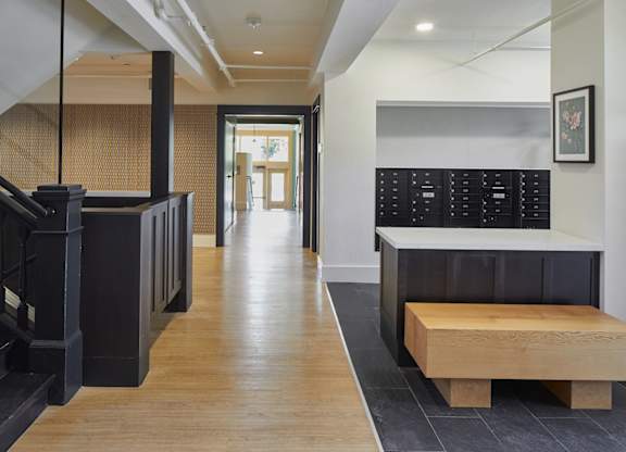 A hallway with a bench and a staircase.
