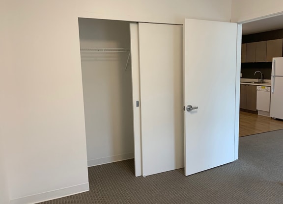 an empty room with an open closet door